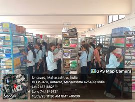 Students browsing the library bookshelves